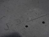a close up of a metal plate with writing on it
