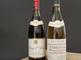 two bottles of wine sitting on top of a wooden table