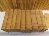 a lot of books that are stacked on top of each other