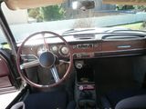 a dashboard and steering wheel of a car in a car showroom