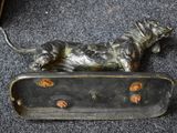 statue of a dog on a skateboard on a carpeted floor