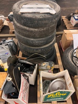a pile of old tires and other items on a pallet