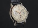 a close up of a watch on a black background