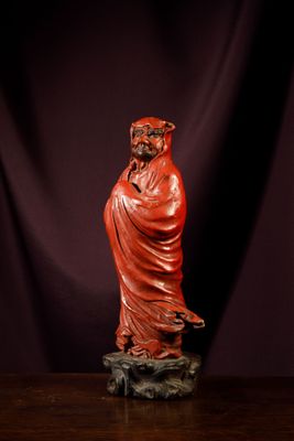 an image of a statue of a man in a red robe