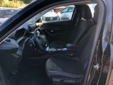 the interior of a car with the door open and the driver ' s seat down