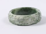 green jade bangle with flowers and leaves on it