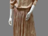 an image of a mannequin dressed in a peach dress