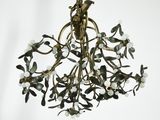 a chandelier hanging from the ceiling with flowers on it