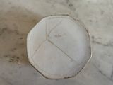 a white plate on a marble table with writing on it