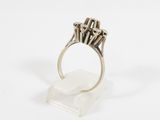 a close up of a silver ring on a clear stand