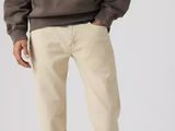 a man wearing a brown hoodie and khaki pants