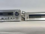 two stereo systems sitting next to each other on a table