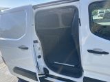 a white van with the door open on the side of the road