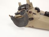 a small toy gun that is sitting on a white surface