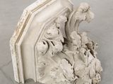 a sculpture of a bookend with a bird on top of it
