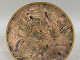 a picture of a decorative plate on a white surface