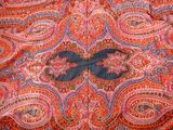 an image of a red and blue paisley pattern with a black butterfly on it