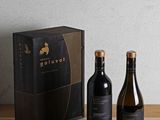two bottles of wine sitting on a table next to a box