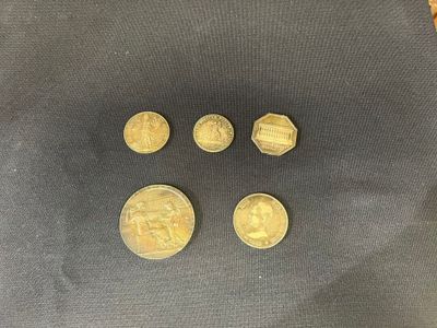 a close up of four gold coins on a black surface