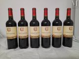 six bottles of wine are lined up on a table