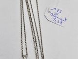 a close up of a necklace on a white surface with a price tag