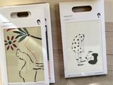 two boxes with drawings on them sitting on a table