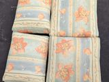 four pillows are sitting on top of a black surface