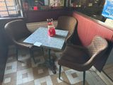 two chairs and a table in the corner of a restaurant
