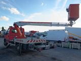 a crane that is sitting on a truck in a parking lot