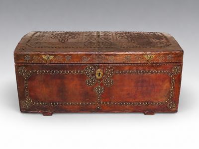 an old wooden trunk with ornate carvings and rivets on the sides