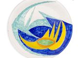 a painting of a sailboat on a blue and yellow plate