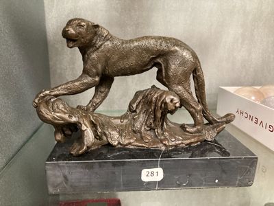 a bronze statue of a dog and a dog on a table