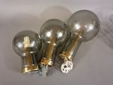 three light bulbs on a table with a white background