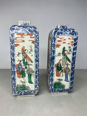 pair of chinese blue and white vases with figures on them
