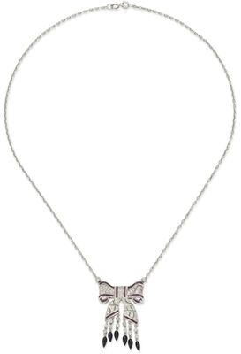 a silver necklace with black and white crystals on a chain