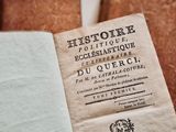 a book that is open on a table with other books