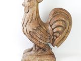 a wooden statue of a rooster on a white background