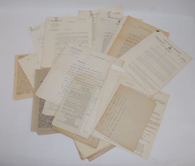 a lot of old papers on a white table