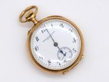 an antique pocket watch on a white surface with a gold case