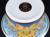 a blue and yellow bowl with a gold design on it