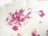 a white plate with a pink floral design on it