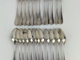 a lot of spoons and forks on the table