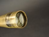 an old brass telescope with a glass on top of it
