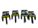 four black and yellow plastic forks are lined up against a white background