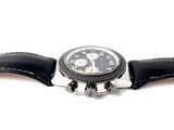 a watch that is sitting on a black leather strap
