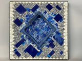 a close up of a blue and white mosaic tile with a square in the middle