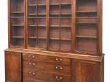 an image of a large wooden bookcase with drawers and shelves