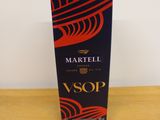 a bottle of wine sitting on top of a wooden table