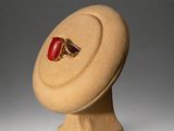 a ring sitting on top of a hat on a stand