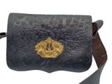 black leather purse with a gold buckle on the front